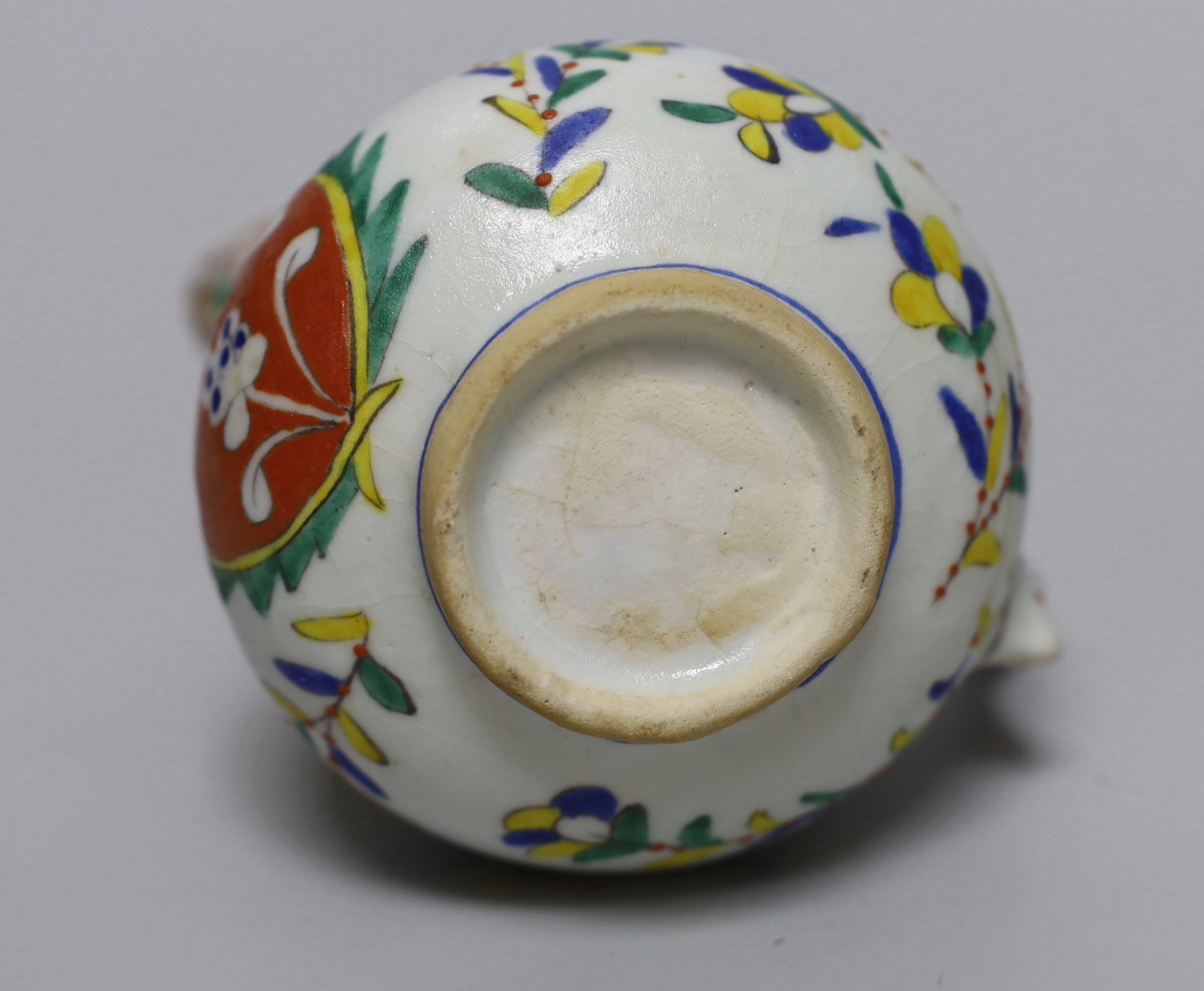 Turkish Kutahya pottery jug hand painted with stylised flowers, 12.5cm high